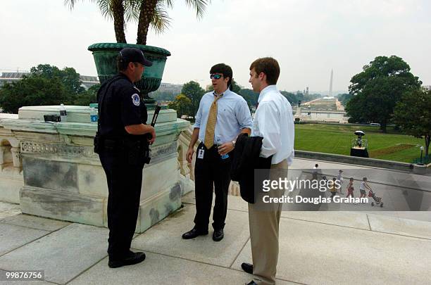 Capitol Policeman Charles Burnside talks with staffers about what to expect as they closed down the exits of the West Front. Security is tight as the...