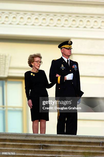 Former First Lady Nancy Reagan watches as the 3rd Infantry Division Old Guard transfer former President Ronald Reagan's casket from the horse-drawn...