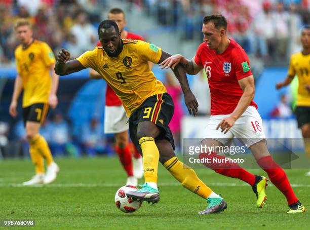 Romelu Lukaku of the Belgium national football team and Phil Jones of the England national football team vie for the ball during the 2018 FIFA World...