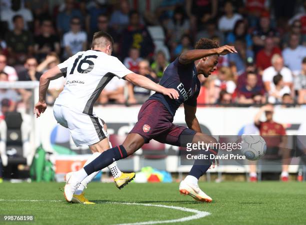 Jeff Reine-Adelaide of Arsenal takes on Bradley Ash of Borehamwood during the match between Borehamwood and Arsenal at Meadow Park on July 14, 2018...