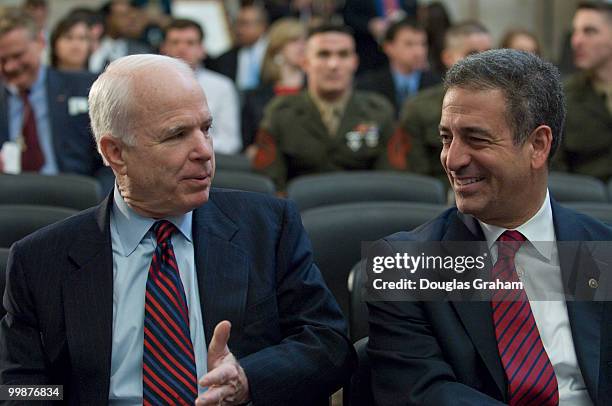 John McCain, R-AZ., and Russ Feingold, D-WI., talk before the start of the Congressional Remembrance Ceremony on Thursday, March 13, 2008 to honor...