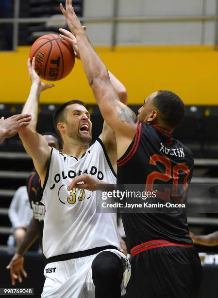 Kyle Austin of the Kimchi Express blocks a shot by Austin Dufault of Team Colorado during the game at Eagle's Nest Arena on July 14, 2018 in Los...