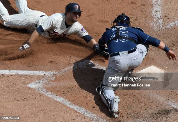 Jesus Sucre of the Tampa Bay Rays defends home plate as he tags out Brian Dozier of the Minnesota Twins during the sixth inning of the game on July...
