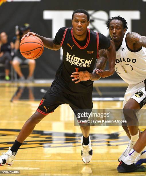 Marcus Hall of Team Colorado chases down Marqueze Coleman of the Kimchi Express as he takes the ball down court in The Basketball Tournament Western...