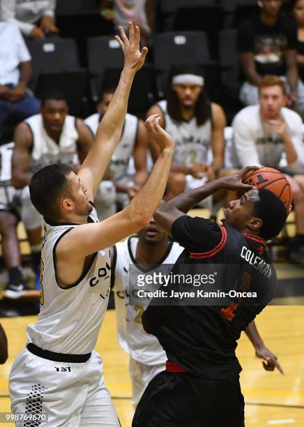 Austin Dufault of Team Colorado defends a shot by Marqueze Coleman of the Kimchi Express in The Basketball Tournament Western Regional game at...