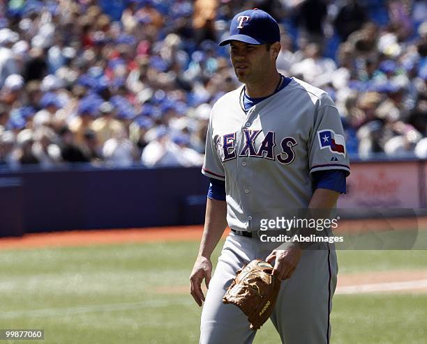 Colby Lewis of the Texas Rangers leaves the game against the Toronto Blue Jays during a MLB game at the Rogers Centre on May 16, 2010 in Toronto,...