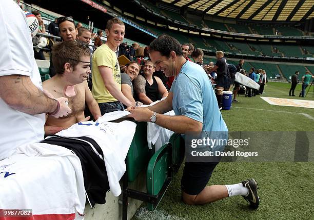 Martin Johnson, the England head coach signs autographs for soldiers based at Headley Court during an England open training session held at...