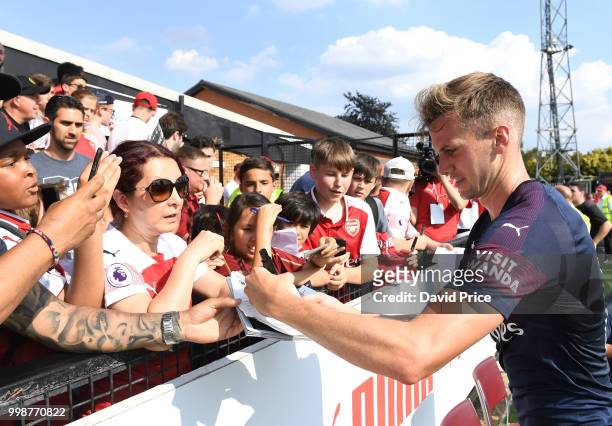 Rob Holding of Arsenal signs his autograph for the fans after the match between Borehamwood and Arsenal at Meadow Park on July 14, 2018 in...