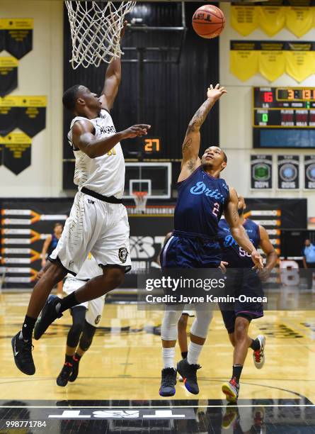 Tyler Larson of the Broad St. Brawlers defends a shot by Jerome Randle of Eberlein Drive in The Basketball Tournament Western Regional game at...