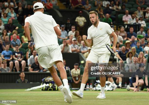Player Mike Bryan and US player Jack Sock react during their mens' doubles final match against South Africa's Raven Klaasen and New Zealand's Michael...