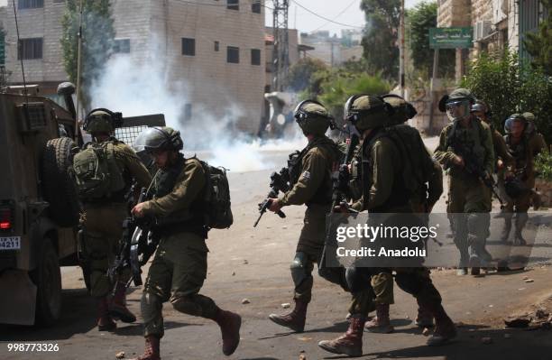 Israeli security forces intervene Palestinians with tear gas as they stage a protest after the funeral of Rami Sabarine, who was killed by Israeli...