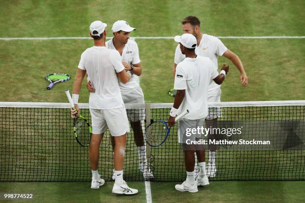 Mike Bryan and Jack Sock of The United States shake hands with Raven Klaasen of South Africa and Michael Venus of New Zealand after the Men's Doubles...