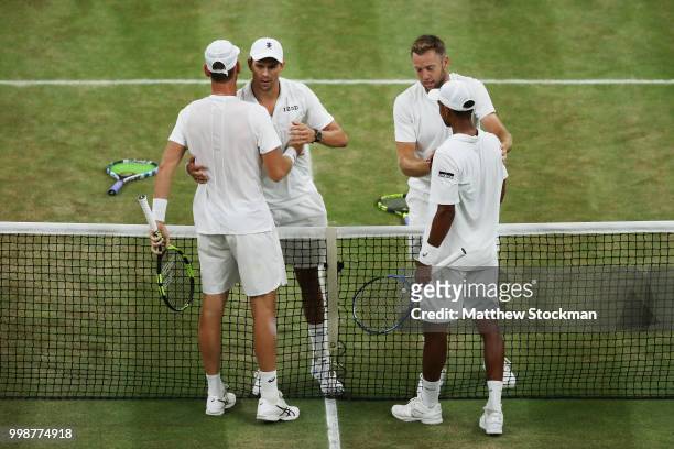 Mike Bryan and Jack Sock of The United States shake hands with Raven Klaasen of South Africa and Michael Venus of New Zealand after the Men's Doubles...