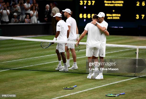 Mike Bryan and Jack Sock of The United States shake hands with Raven Klaasen of South Africa and Michael Venus of New Zealand after the Men's Doubles...