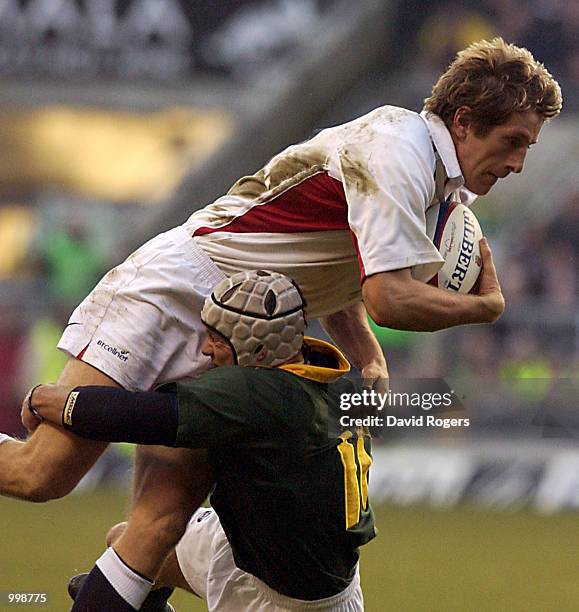 Will Greenwood of England is stopped by Louis Koen of South Africa during the Investec Challenge match between England and South Africa at...