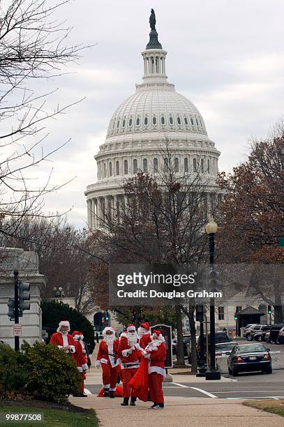 Large numbers of Santa's or Santa's helpers where out in force Wednesday morning handing out lumps of coal to Hill staffers on their way to work near...