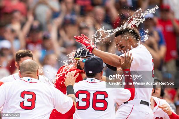 Xander Bogaerts of the Boston Red Sox reacts with teammates after hitting a walk-off grand slam home run during the tenth inning of a game against...