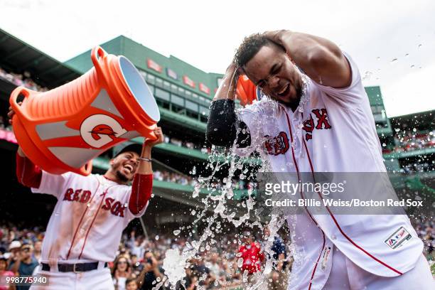 Xander Bogaerts of the Boston Red Sox reacts as he is doused with Gatorade by Mookie Betts after hitting a walk-off grand slam home run during the...