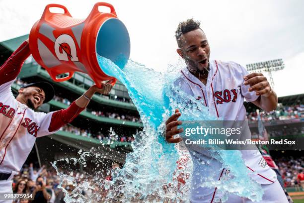 Xander Bogaerts of the Boston Red Sox reacts as he is doused with Gatorade by Mookie Betts after hitting a walk-off grand slam home run during the...