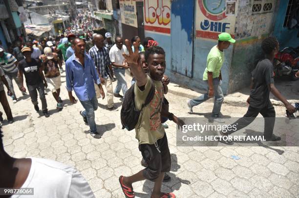 Demonstrators marched through the streets of Port-au-Prince, on July 14, 2018 to protest against the government of President Jovenel Moise and...