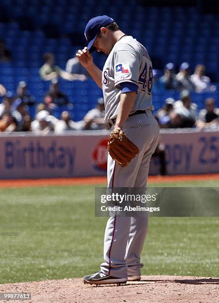 Colby Lewis of the Texas Rangers prepares for a pitch against the Toronto Blue Jays during a MLB game at the Rogers Centre on May 16, 2010 in...