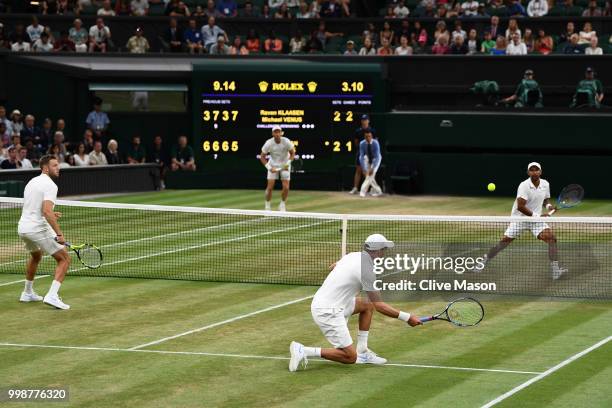 Mike Bryan and Jack Sock of The United States return against Raven Klaasen of South Africa and Michael Venus of New Zealand during the Men's Doubles...