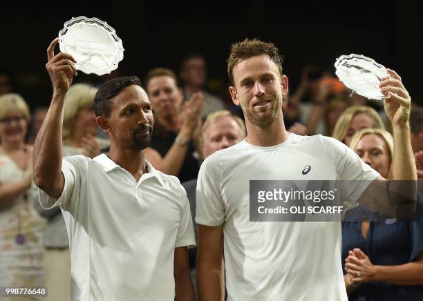 Runners up South Africa's Raven Klaasen and New Zealand's Michael Venus pose with their platers after losing to US player Mike Bryan and US player...