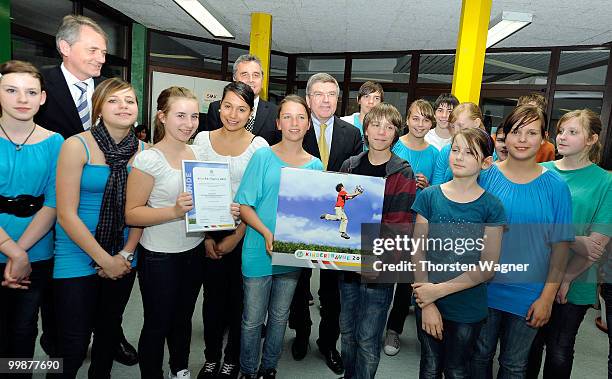 Thomas Bach, head of German Olympic Sports Association poses with children during the Children's dreams 2011 awards ceremony at the Riemenschneider...