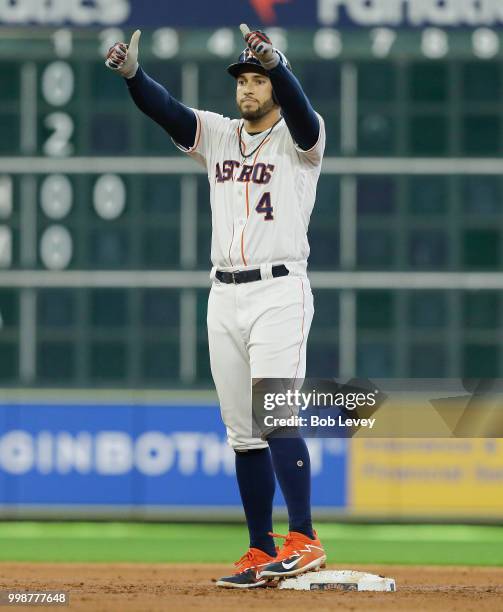 George Springer of the Houston Astros doubles in the second inning against the Detroit Tigers at Minute Maid Park on July 14, 2018 in Houston, Texas.