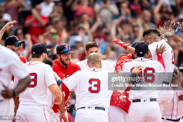 Xander Bogaerts of the Boston Red Sox reacts with teammates after hitting a walk-off grand slam home run during the tenth inning of a game against...