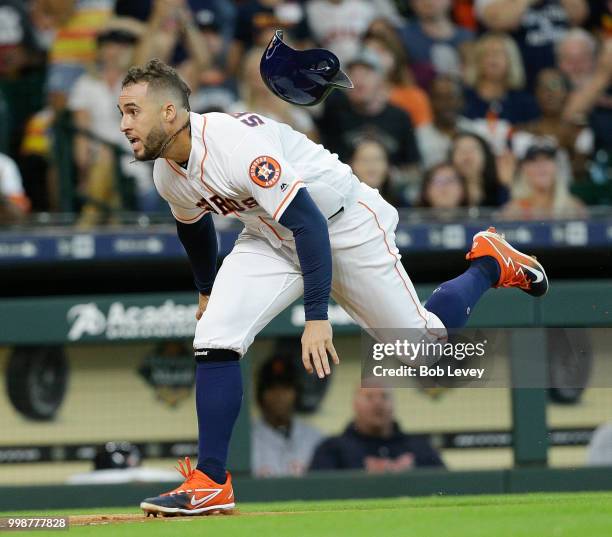 George Springer of the Houston Astros attempts to score in the second inning on a single by Alex Bregman against the Detroit Tigers at Minute Maid...