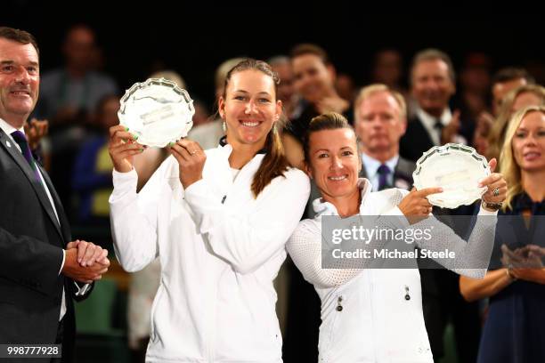 Nicole Melichar of The United States and Kveta Peschke of Czech Republic pose with their runner-up trophies in Centre Court after Barbora Krejcikova...