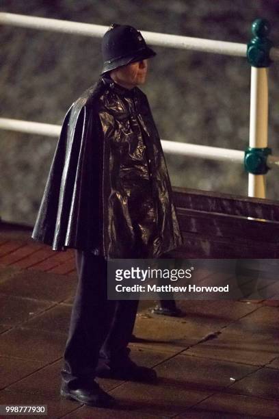 An actor dressed as a police officer seen during filming for 'Six Minutes to Midnight' on Penarth seafront on July 14, 2018 in Penarth, Wales.