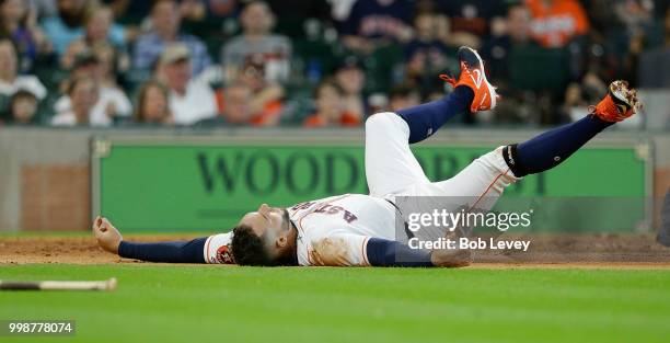 George Springer of the Houston Astros attempts to score in the second inning on a single by Alex Bregman against the Detroit Tigers at Minute Maid...