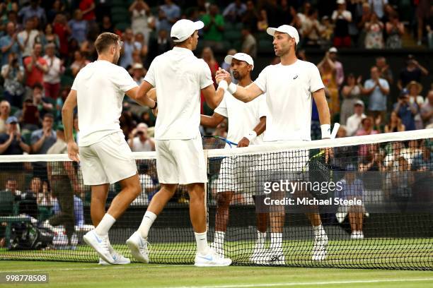 Mike Bryan and Jack Sock of The United States shake hands with Raven Klaasen of South Africa and Michael Venus of New Zealand after the Men's Doubles...