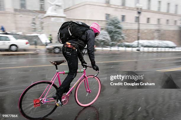 Like the postman bicycle messengers work in rain and snow as this messenger heads West on Independence Ave. In the first snow of the on Capitol Hill...