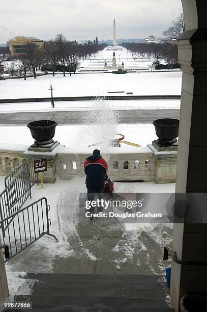 Workers clean the West Front Terrace of the U.S. Capitol after an overnight ice storm left most of the Washington area with school closures and a...