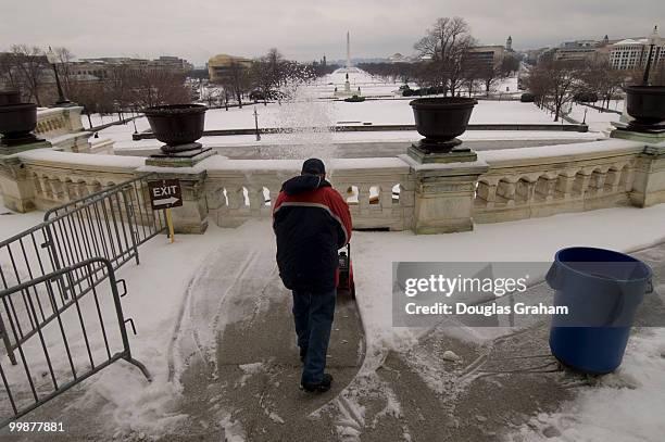 Workers clean the West Front Terrace of the U.S. Capitol after an overnight ice storm left most of the Washington area with school closures and a...