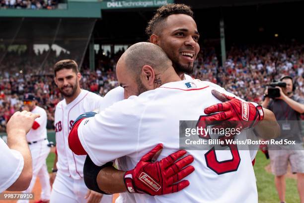 Xander Bogaerts of the Boston Red Sox reacts with Sandy Leon after hitting a walk-off grand slam home run during the tenth inning of a game against...