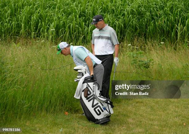 Kevin Sutherland and his caddie search for his golf ball behind the second green during the third round of the PGA TOUR Champions Constellation...