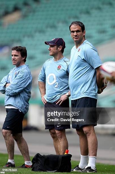 Martin Johnson, the England head coach looks on with his assistant coaches Brian Smith and Mike Ford during an England training session held at...