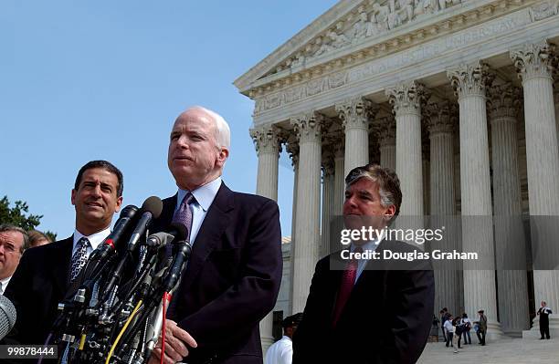 Russell D. Feingold, D-WI., John McCain, R-AZ., and Martin T. Meehan, D-MA., face the press during the lunch recess at the Supreme Court where oral...