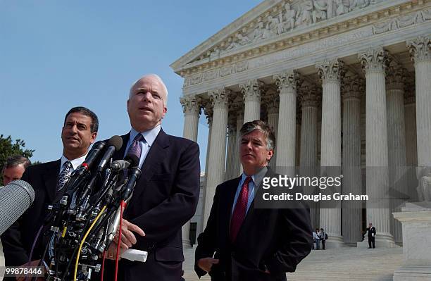 Russell D. Feingold, D-WI., John McCain, R-AZ., and Martin T. Meehan, D-MA., face the press during the lunch recess at the Supreme Court where oral...