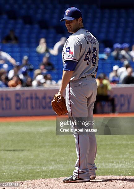 Colby Lewis of the Texas Rangers prepares for a pitch against the Toronto Blue Jays during a MLB game at the Rogers Centre on May 16, 2010 in...