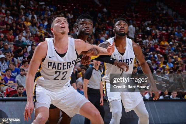 Chimezie Metu of the San Antonio Spurs battles for position against T.J. Leaf and Travis Leslie of the Indiana Pacers during the 2018 Las Vegas...