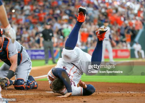 Houston Astros center fielder George Springer does a back flip after barreling into Detroit Tigers catcher James McCann during the baseball game...