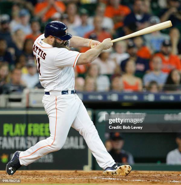 Evan Gattis of the Houston Astros hits a home run in the fifth inning against the Detroit Tigers at Minute Maid Park on July 14, 2018 in Houston,...