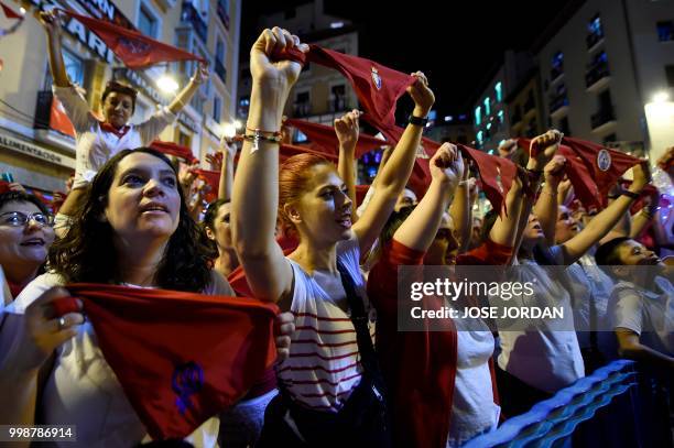 Revellers raise red scarves and candles as they sing the song 'Pobre de Mi', marking the end of the San Fermin festival in Pamplona, northern Spain...