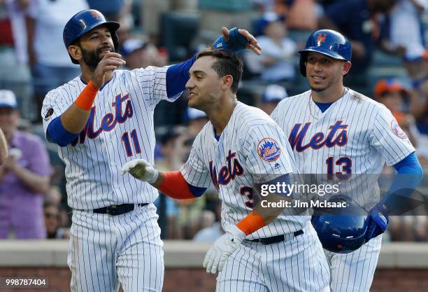 Michael Conforto of the New York Mets celebrates his fifth inning three run home run against the Washington Nationals with teammates Jose Bautista...