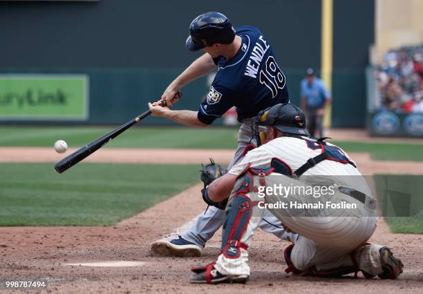 Joey Wendle of the Tampa Bay Rays hits a two-run triple as Bobby Wilson of the Minnesota Twins catches during the seventh inning of the game on July...